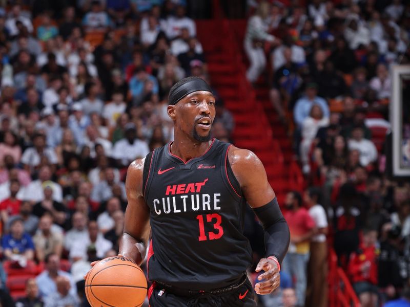 MIAMI, FL - MARCH 26:  Bam Adebayo #13 of the Miami Heat dribbles the ball during the game against the Golden State Warriors on March 26, 2024 at Kaseya Center in Miami, Florida. NOTE TO USER: User expressly acknowledges and agrees that, by downloading and or using this Photograph, user is consenting to the terms and conditions of the Getty Images License Agreement. Mandatory Copyright Notice: Copyright 2024 NBAE (Photo by Jeff Haynes/NBAE via Getty Images)