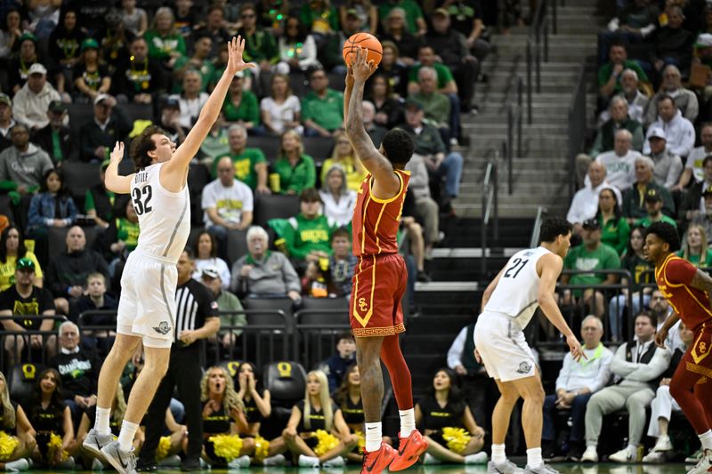 Mar 1, 2025; Eugene, Oregon, USA; USC Trojans forward Rashaun Agee (12) shoots the ball over Oregon Ducks center Nate Bittle (32) during the first half at Matthew Knight Arena. Mandatory Credit: Craig Strobeck-Imagn Images