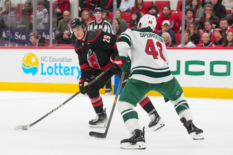 Nov 6, 2025; Raleigh, North Carolina, USA;  Carolina Hurricanes left wing Bradly Nadeau (29) gets ready to take a shot against Minnesota Wild defenseman Jared Spurgeon (46) during the third period at Lenovo Center. Mandatory Credit: James Guillory-Imagn Images