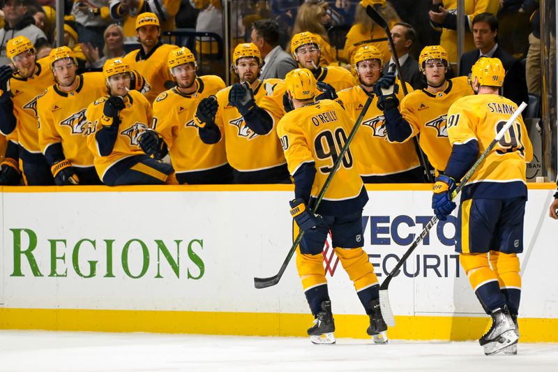 Oct 22, 2024; Nashville, Tennessee, USA;  Nashville Predators center Ryan O'Reilly (90) celebrates his goal with his teammates  against the Boston Bruins during the first period at Bridgestone Arena. Mandatory Credit: Steve Roberts-Imagn Images