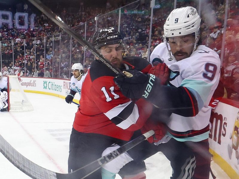 Dec 6, 2024; Newark, New Jersey, USA; New Jersey Devils right wing Stefan Noesen (11) hits Seattle Kraken center Chandler Stephenson (9) during the second period at Prudential Center. Mandatory Credit: Ed Mulholland-Imagn Images