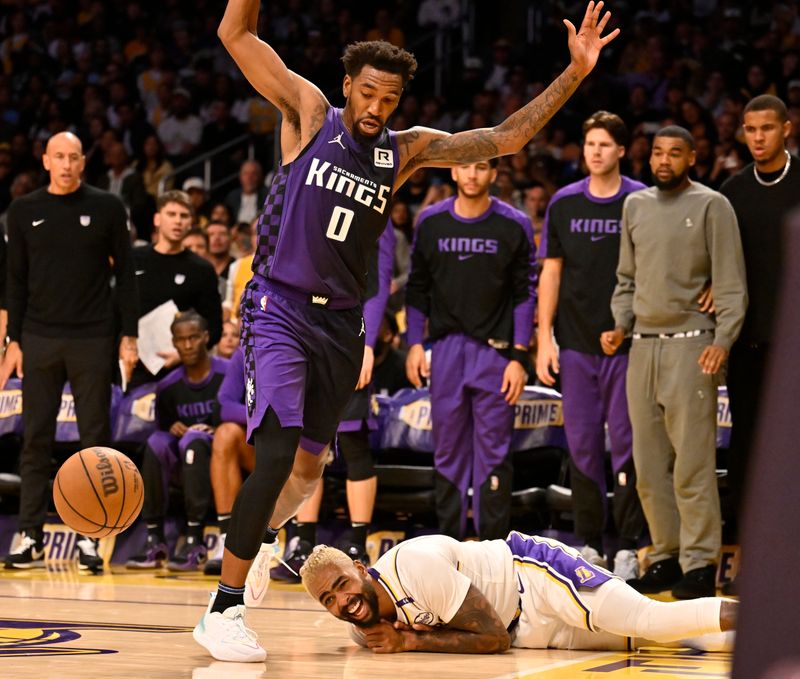 LOS ANGELES, CALIFORNIA - OCTOBER 26: Malik Monk #0 of the Sacramento Kings jumps over D'Angelo Russell #1 of the Los Angeles Lakers in the second half at Crypto.com Arena on October 26, 2024 in Los Angeles, California. NOTE TO USER: User expressly acknowledges and agrees that, by downloading and or using this photograph, User is consenting to the terms and conditions of the Getty Images License Agreement. (Photo by John McCoy/Getty Images)