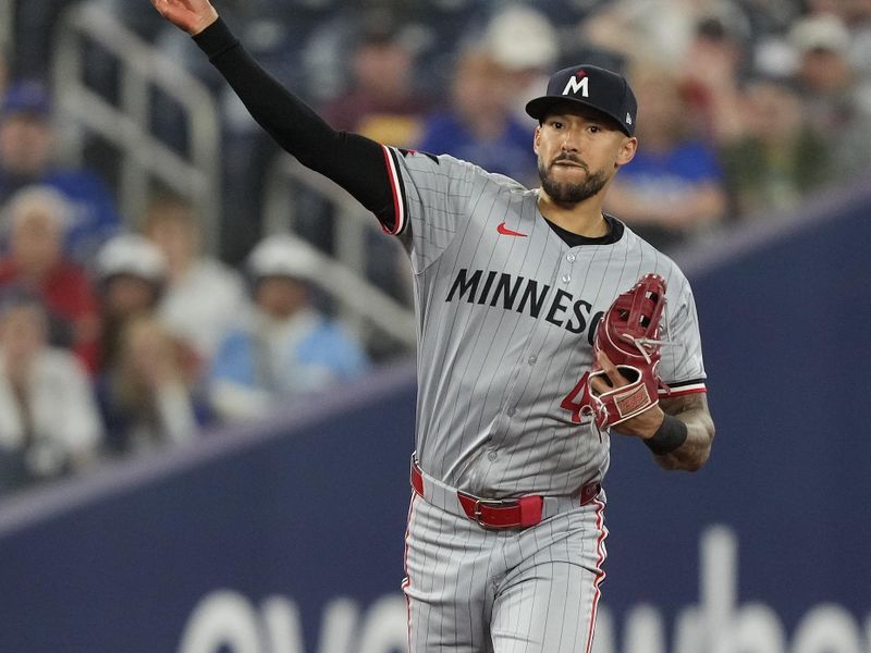 May 10, 2024; Toronto, Ontario, CAN; Minnesota Twins shortstop Carlos Correa (4) throws to first to get out Toronto Blue Jays designated hitter Justin Turner (not pictured) during the ninth inning at Rogers Centre. Mandatory Credit: John E. Sokolowski-USA TODAY Sports