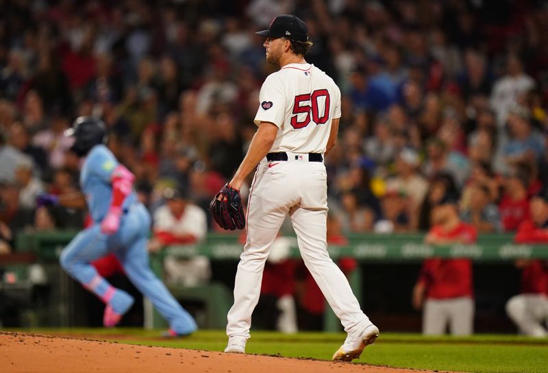 Aug 29, 2024; Boston, Massachusetts, USA; Boston Red Sox starting pitcher Kutter Crawford (50) looks on as Toronto Blue Jays designated hitter Vladimir Guerrero Jr. (27) hits a double to drive in a run in the third inning at Fenway Park. Mandatory Credit: David Butler II-USA TODAY Sports