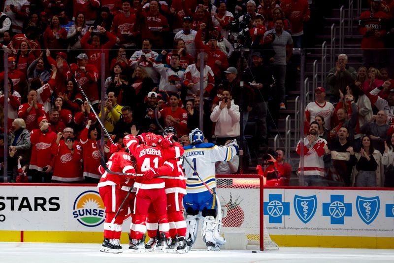 Apr 7, 2024; Detroit, Michigan, USA; Detroit Red Wings center Dylan Larkin (71) receives congratulations from teammates after scoring in the first period against the Buffalo Sabres at Little Caesars Arena. Mandatory Credit: Rick Osentoski-USA TODAY Sports