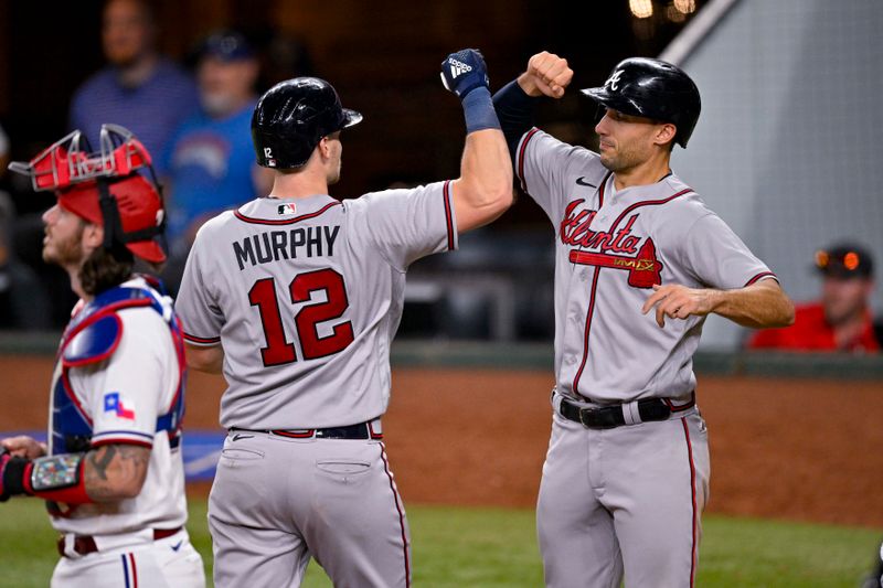 May 16, 2023; Arlington, Texas, USA; Atlanta Braves catcher Sean Murphy (12) and first baseman Matt Olson (28) celebrate after Murphy hits a two run home run against the Texas Rangers during the eighth inning at Globe Life Field. Mandatory Credit: Jerome Miron-USA TODAY Sports