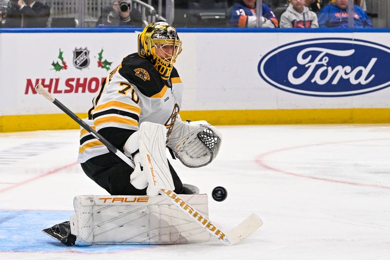 Nov 27, 2024; Elmont, New York, USA;  Boston Bruins goaltender Joonas Korpisalo (70) makes a save against the New York Islanders during the second period at UBS Arena. Mandatory Credit: Dennis Schneidler-Imagn Images