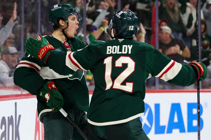 Oct 10, 2024; Saint Paul, Minnesota, USA; Minnesota Wild center Joel Eriksson Ek (14) celebrates his goal with left wing Matt Boldy (12) against the Columbus Blue Jackets during the second period at Xcel Energy Center. Mandatory Credit: Matt Krohn-Imagn Images