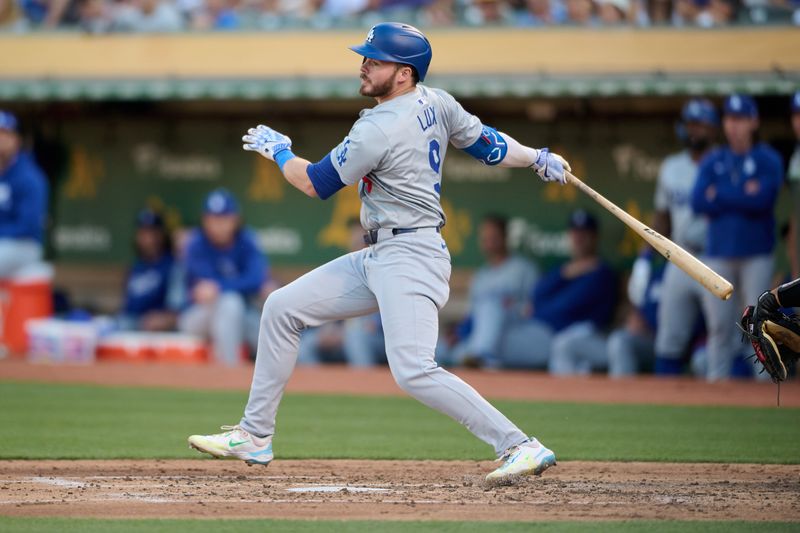 Aug 3, 2024; Oakland, California, USA; Los Angeles Dodgers infielder Gavin Lux (9) hits an RBI single against the Oakland Athletics during the third inning at Oakland-Alameda County Coliseum. Mandatory Credit: Robert Edwards-USA TODAY Sports