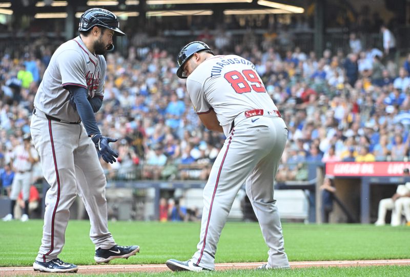 Jul 31, 2024; Milwaukee, Wisconsin, USA; Atlanta Braves catcher Travis d'Arnaud (16) celebrates with third base coach Matt Tuiasosopo (89) after hitting a home run against the Atlanta Braves at American Family Field. Mandatory Credit: Michael McLoone-USA TODAY Sports