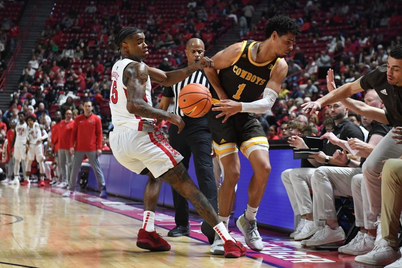 Feb 3, 2024; Las Vegas, Nevada, USA; Wyoming Cowboys guard Brendan Wenzel (1) keeps the ball inbounds against UNLV Rebels guard Luis Rodriguez (15) in the second half at Thomas & Mack Center. Mandatory Credit: Candice Ward-USA TODAY Sports