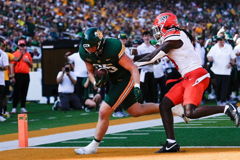 Oct 26, 2024; Waco, Texas, USA;  Baylor Bears tight end Matthew Klopfenstein (85) scores a touchdown against Oklahoma State Cowboys linebacker Andrew McCall (53) during the first half at McLane Stadium. Mandatory Credit: Chris Jones-Imagn Images