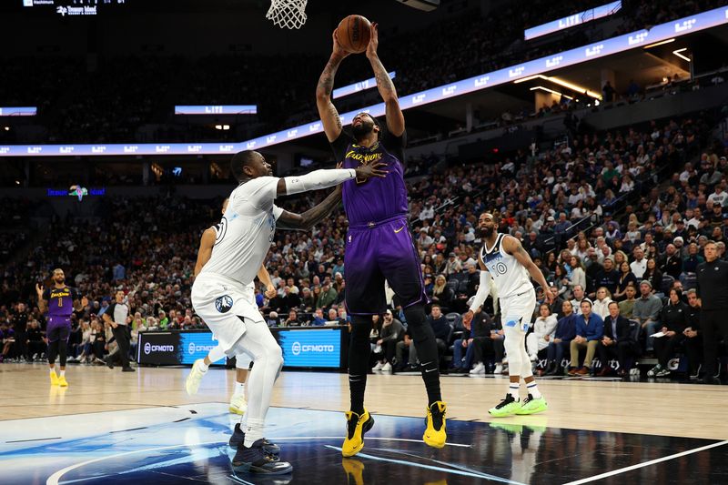 MINNEAPOLIS, MINNESOTA - DECEMBER 02: Anthony Davis #3 of the Los Angeles Lakers goes up for a shot against Julius Randle #30 of the Minnesota Timberwolves in the third quarter at Target Center on December 02, 2024 in Minneapolis, Minnesota. The Timberwolves defeated the Lakers 109-80. NOTE TO USER: User expressly acknowledges and agrees that, by downloading and or using this photograph, User is consenting to the terms and conditions of the Getty Images License Agreement. (Photo by David Berding/Getty Images)