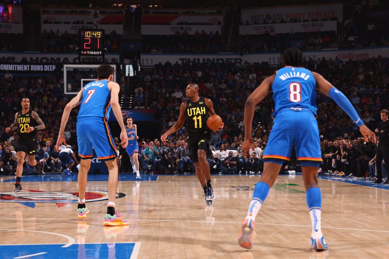 OKLAHOMA CITY, OK - MARCH 20: Kris Dunn #11 of the Utah Jazz dribbles the ball during the game against the Oklahoma City Thunder on March 20, 2024 at Paycom Arena in Oklahoma City, Oklahoma. NOTE TO USER: User expressly acknowledges and agrees that, by downloading and or using this photograph, User is consenting to the terms and conditions of the Getty Images License Agreement. Mandatory Copyright Notice: Copyright 2024 NBAE (Photo by Zach Beeker/NBAE via Getty Images)