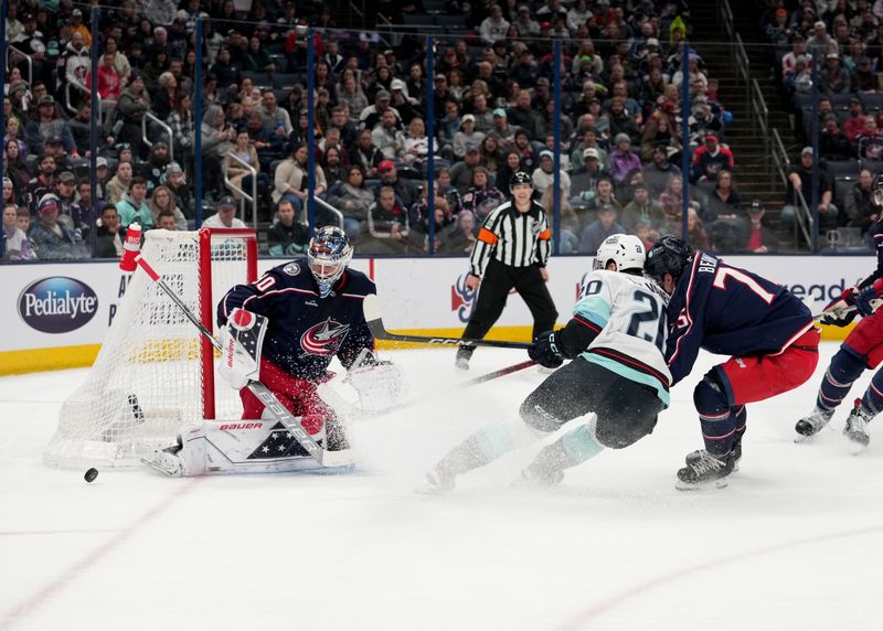 Mar 3, 2023; Columbus, Ohio, USA; Columbus Blue Jackets goaltender Elvis Merzlikins (90) deflects a shot from Seattle Kraken right wing Eeli Tolvanen (20) during the first period at Nationwide Arena. Mandatory Credit: Jason Mowry-USA TODAY Sports