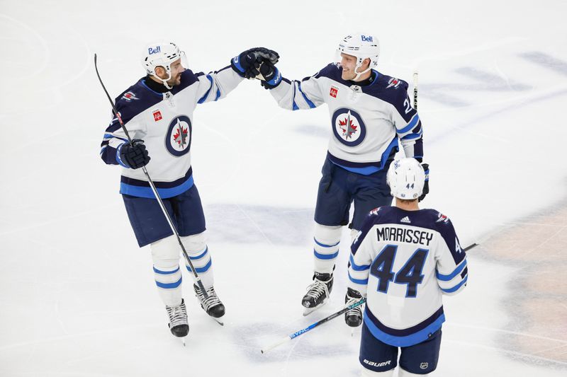 Feb 23, 2024; Chicago, Illinois, USA; Winnipeg Jets left wing Nikolaj Ehlers (27) celebrates with teammaes after scoring against the Chicago Blackhawks during the second period at United Center. Mandatory Credit: Kamil Krzaczynski-USA TODAY Sports