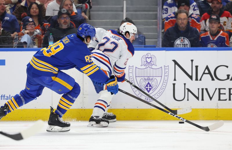 Nov 17, 2025; Buffalo, New York, USA;  Edmonton Oilers center Matt Savoie (22) controls the puck as Buffalo Sabres right wing Alex Tuch (89) defends during the third period at KeyBank Center. Mandatory Credit: Timothy T. Ludwig-Imagn Images