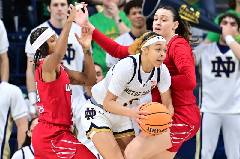 Mar 3, 2024; South Bend, Indiana, USA; Notre Dame Fighting Irish guard Hannah Hidalgo (3) passes the ball as Louisville Cardinals guard Nina Rickards (15) and forward Elif Istanbulluoglu (11) defend in the first half at the Purcell Pavilion. Mandatory Credit: Matt Cashore-USA TODAY Sports