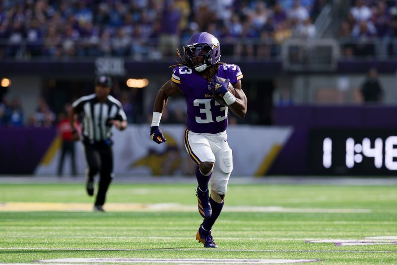 Minnesota Vikings running back Aaron Jones (33) carries the ball down the field for a touchdown against the Detroit Lions during the first half of an NFL football game Sunday, Oct. 20, 2024 in Minneapolis. (AP Photo/Stacy Bengs)