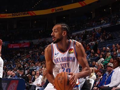 OKLAHOMA CITY, OK - DECEMBER 18:  Olivier Sarr #30 of the Oklahoma City Thunder  handles the ball during the game against the Memphis Grizzlies on December 18, 2023 at Paycom Arena in Oklahoma City, Oklahoma. NOTE TO USER: User expressly acknowledges and agrees that, by downloading and or using this photograph, User is consenting to the terms and conditions of the Getty Images License Agreement. Mandatory Copyright Notice: Copyright 2023 NBAE (Photo by Zach Beeker/NBAE via Getty Images)