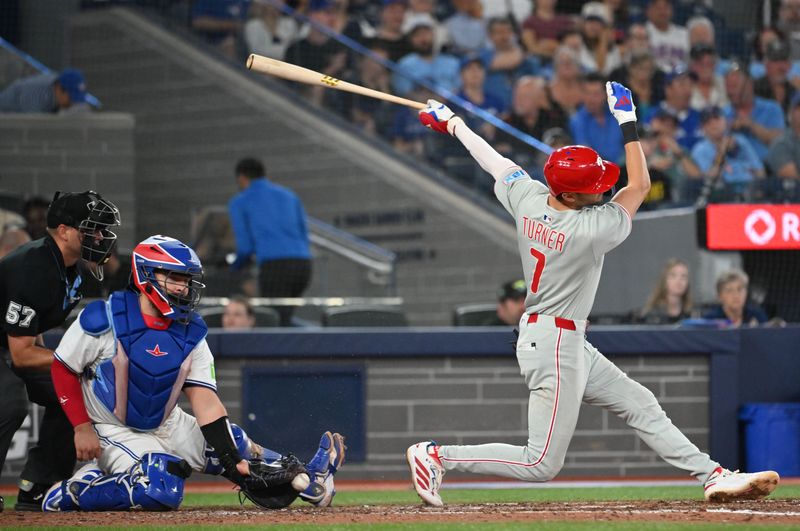 Jun 4, 2025; Toronto, Ontario, CAN;  Toronto Blue Jays catcher Alejandro Kirk (30) blocks a low pitch as Philadelphia Phillies shortstop Trea Turner (7) strikes out swinging in the eighth inning at Rogers Centre. Mandatory Credit: Dan Hamilton-Imagn Images