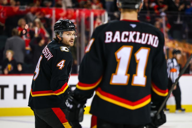 Nov 19, 2024; Calgary, Alberta, CAN; Calgary Flames defenseman Rasmus Andersson (4) scores a goal against the New York Islanders during the third period at Scotiabank Saddledome. Mandatory Credit: Sergei Belski-Imagn Images