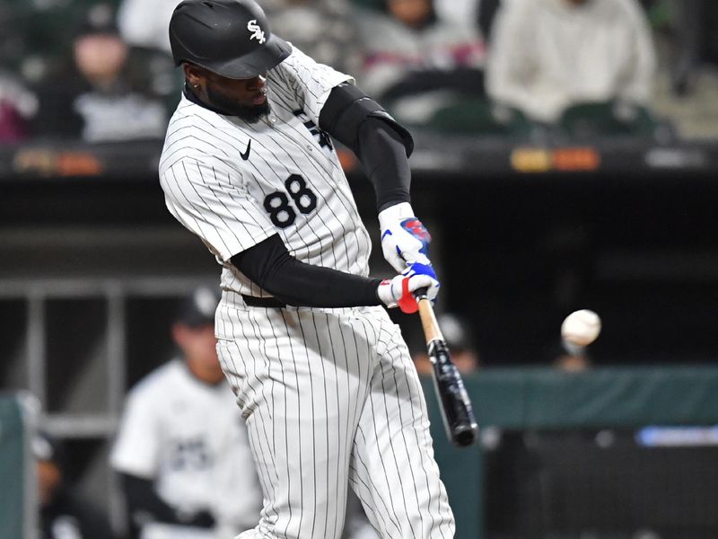 Apr 2, 2024; Chicago, Illinois, USA; Chicago White Sox center fielder Luis Robert Jr. (88) doubles during the eighth inning againnst the Atlanta Braves at Guaranteed Rate Field. Mandatory Credit: Patrick Gorski-USA TODAY Sports