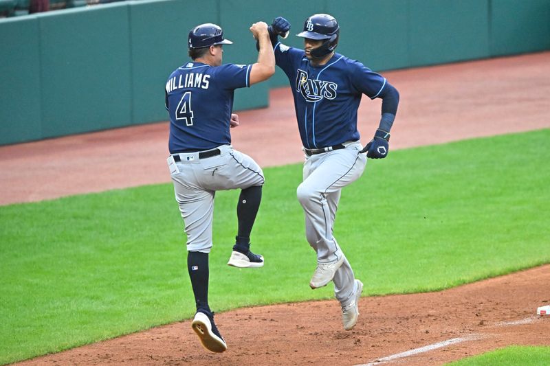 Sep 2, 2023; Cleveland, Ohio, USA; Tampa Bay Rays catcher Christian Bethancourt (14) celebrates with third base coach Brady Williams (4) after hitting a three-run home run against the Cleveland Guardians in the fifth inning at Progressive Field. Mandatory Credit: David Richard-USA TODAY Sports