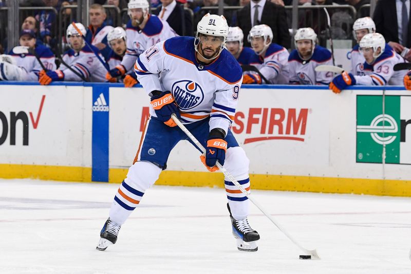 Dec 22, 2023; New York, New York, USA;  Edmonton Oilers left wing Evander Kane (91) skates across the blue line against the New York Rangers during the third period at Madison Square Garden. Mandatory Credit: Dennis Schneidler-USA TODAY Sports