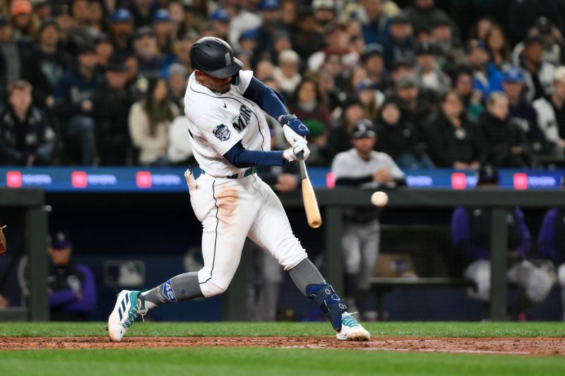 Apr 15, 2023; Seattle, Washington, USA; Seattle Mariners center fielder Julio Rodriguez (44) hits a 3-RBI triple against the Colorado Rockies during the fourth inning at T-Mobile Park. Mandatory Credit: Steven Bisig-USA TODAY Sports