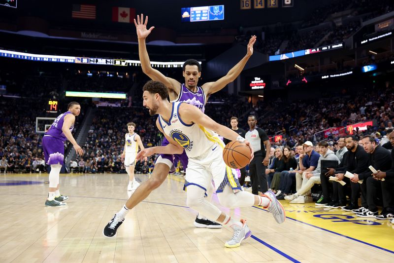 SAN FRANCISCO, CALIFORNIA - APRIL 14: Klay Thompson #11 of the Golden State Warriors is guarded by Darius Bazley #21 of the Utah Jazz  in the first half at Chase Center on April 14, 2024 in San Francisco, California. NOTE TO USER: User expressly acknowledges and agrees that, by downloading and or using this photograph, User is consenting to the terms and conditions of the Getty Images License Agreement.  (Photo by Ezra Shaw/Getty Images)