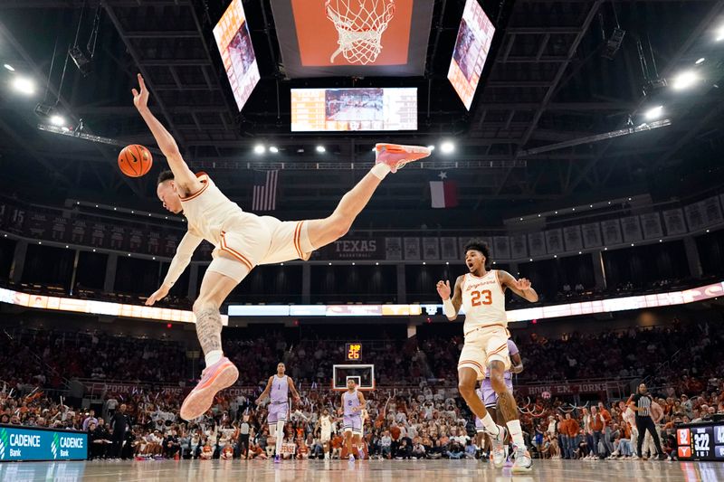 Feb 19, 2024; Austin, Texas, USA; Texas Longhorns guard Chendall Weaver (2) falls to the ground and forward Dillon Mitchell (23) reacts after a flagrant foul is committed during the second half against the Kansas State Wildcats at Moody Center. Mandatory Credit: Scott Wachter-USA TODAY Sports