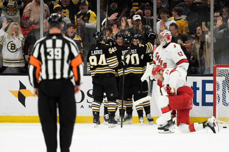 Apr 9, 2024; Boston, Massachusetts, USA; Boston Bruins defenseman Charlie McAvoy (73) is congratulated by his teammates after scoring a goal during the second period against the Carolina Hurricanes at TD Garden. Mandatory Credit: Bob DeChiara-USA TODAY Sports