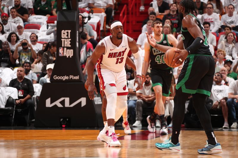 MIAMI, FL - APRIL 27: Bam Adebayo #13 of the Miami Heat plays defense against Jaylen Brown #7 of the Boston Celtics during the game during Round 1 Game 3 of the 2024 NBA Playoffs on April 27, 2024 at Kaseya Center in Miami, Florida. NOTE TO USER: User expressly acknowledges and agrees that, by downloading and or using this Photograph, user is consenting to the terms and conditions of the Getty Images License Agreement. Mandatory Copyright Notice: Copyright 2024 NBAE (Photo by Issac Baldizon/NBAE via Getty Images)