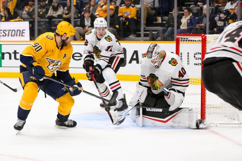 Jan 16, 2025; Nashville, Tennessee, USA;  Chicago Blackhawks goaltender Arvid Soderblom (40) blocks the shot of Nashville Predators center Ryan O'Reilly (90) during the third period at Bridgestone Arena. Mandatory Credit: Steve Roberts-Imagn Images