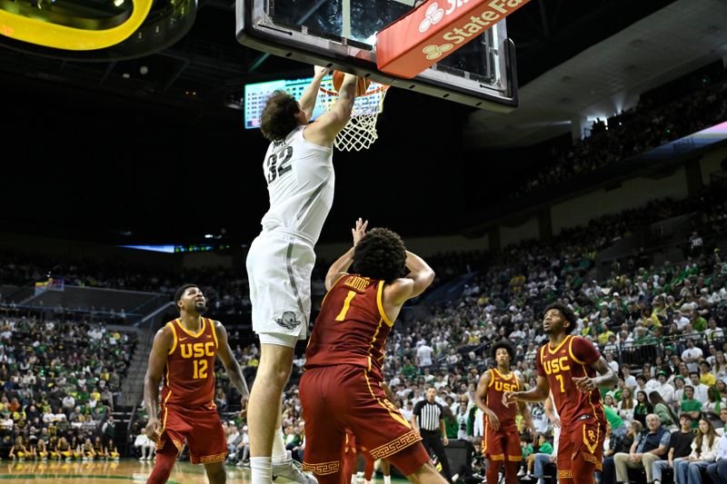 Mar 1, 2025; Eugene, Oregon, USA; Oregon Ducks center Nate Bittle (32) dunks the ball over USC Trojans guard Desmond Claude (1) during the first half at Matthew Knight Arena. Mandatory Credit: Craig Strobeck-Imagn Images