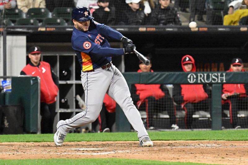 May 2, 2025; Chicago, Illinois, USA;  Houston Astros catcher Yainer Diaz (21) hits a home run during the eighth inning against the Chicago White Sox at Rate Field. Mandatory Credit: Matt Marton-Imagn Images