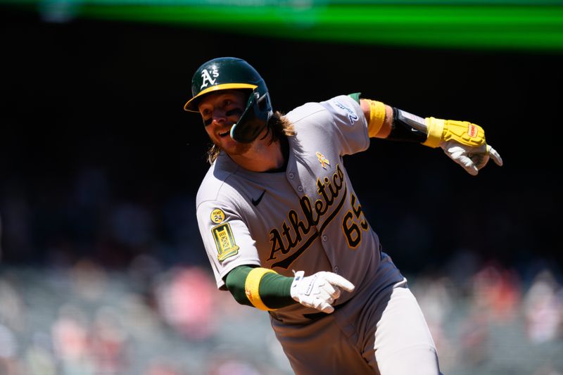 Sep 7, 2025; Anaheim, California, USA; Athletics catcher Willie MacIver (65) runs back to first after realizing he missed stepping on first base after hitting a home run against the Los Angeles Angels during the third inning at Angel Stadium. Mandatory Credit: William Liang-Imagn Images