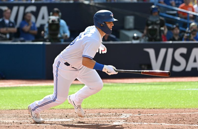 Aug 27, 2023; Toronto, Ontario, CAN;  Toronto Blue Jays center fielder Daulton Varsho (25) hits an RBI single against the Cleveland Guardians in the eighth inning at Rogers Centre. Mandatory Credit: Dan Hamilton-USA TODAY Sports