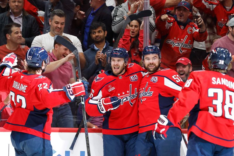 Oct 23, 2024; Washington, District of Columbia, USA; Washington Capitals right wing Taylor Raddysh (16) celebrates with teammates after scoring a goal against the Philadelphia Flyers in the first period at Capital One Arena. Mandatory Credit: Geoff Burke-Imagn Images