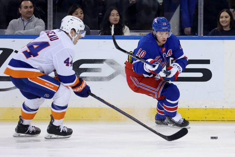 Mar 3, 2025; New York, New York, USA; New York Rangers left wing Artemi Panarin (10) fights for the puck against New York Islanders center Jean-Gabriel Pageau (44) during the first period at Madison Square Garden. Mandatory Credit: Brad Penner-Imagn Images