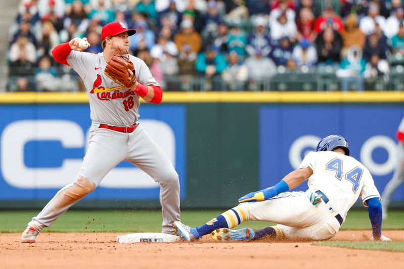 Apr 23, 2023; Seattle, Washington, USA; St. Louis Cardinals second baseman Nolan Gorman (16) turns a double play against Seattle Mariners center fielder Julio Rodriguez (44) during the seventh inning at T-Mobile Park. Mandatory Credit: Joe Nicholson-USA TODAY Sports