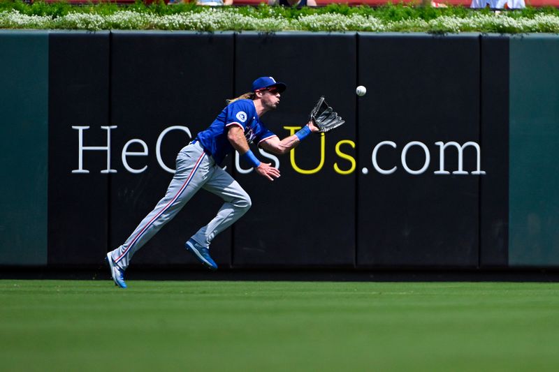 Jul 31, 2024; St. Louis, Missouri, USA;  Texas Rangers center fielder Travis Jankowski (16) catches a fly ball against the St. Louis Cardinals during the third inning at Busch Stadium. Mandatory Credit: Jeff Curry-USA TODAY Sports