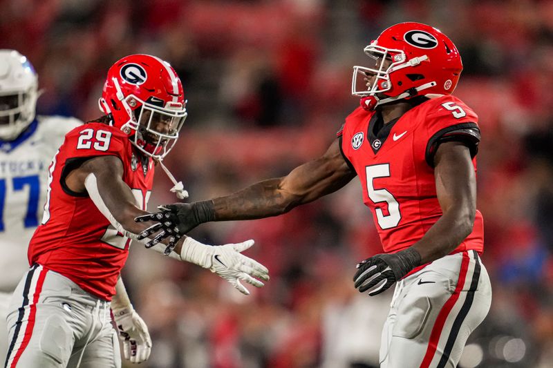 Oct 7, 2023; Athens, Georgia, USA; Georgia Bulldogs linebacker Gabe Harris (29) and  linebacker Raylen Wilson (5) react after a sack against the Kentucky Wildcats during the second half at Sanford Stadium. Mandatory Credit: Dale Zanine-USA TODAY Sports