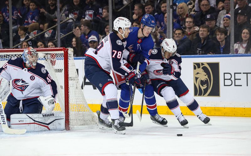 Jan 18, 2025; New York, New York, USA; New York Rangers center Adam Edstrom (84) gets caught between Columbus Blue Jackets defenseman Damon Severson (78) and Columbus Blue Jackets center Cole Sillinger (4) while fighting for the puck behind Columbus Blue Jackets goalie Daniil Tarasov (40) during the first period at Madison Square Garden. Mandatory Credit: Danny Wild-Imagn Images