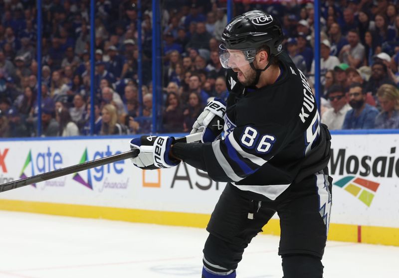 Oct 26, 2024; Tampa, Florida, USA; Tampa Bay Lightning right wing Nikita Kucherov (86) passes the puck against the Washington Capitals during the first period at Amalie Arena. Mandatory Credit: Kim Klement Neitzel-Imagn Images
