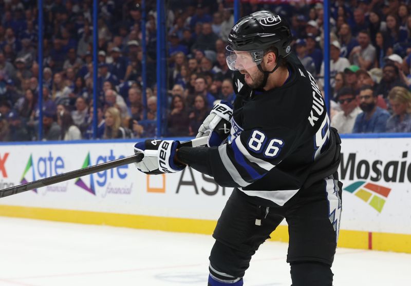 Oct 26, 2024; Tampa, Florida, USA; Tampa Bay Lightning right wing Nikita Kucherov (86) passes the puck against the Washington Capitals during the first period at Amalie Arena. Mandatory Credit: Kim Klement Neitzel-Imagn Images