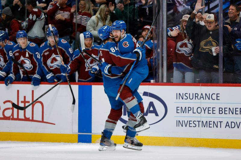Jan 10, 2026; Denver, Colorado, USA; Colorado Avalanche defenseman Ilya Solovyov (28) celebrates his goal with defenseman Brent Burns (84) in the second period against the Columbus Blue Jackets at Ball Arena. Mandatory Credit: Isaiah J. Downing-Imagn Images