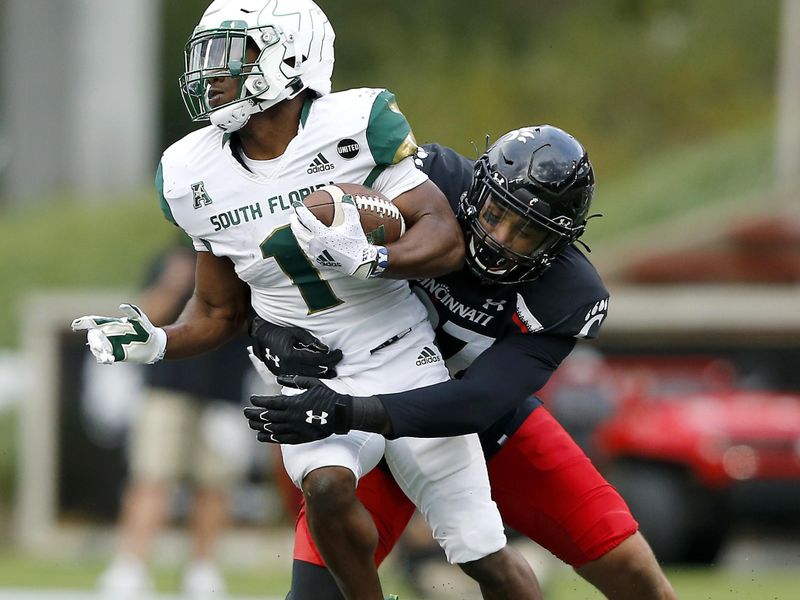 Oct 3, 2020; Cincinnati, OH, USA; South Florida Bulls running back Johnny Ford (1) tackled by Cincinnati Bearcats linebacker Darrian Beavers (27)during the third quarter at Nippert Stadium. Mandatory Credit: Joseph Maiorana-USA TODAY Sports