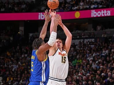 DENVER, CO - DECEMBER 25: Nikola Jokic #15 of the Denver Nuggets three point basket during the game against the Golden State Warriors on December 25, 2023 at the Ball Arena in Denver, Colorado. NOTE TO USER: User expressly acknowledges and agrees that, by downloading and/or using this Photograph, user is consenting to the terms and conditions of the Getty Images License Agreement. Mandatory Copyright Notice: Copyright 2023 NBAE (Photo by Bart Young/NBAE via Getty Images)